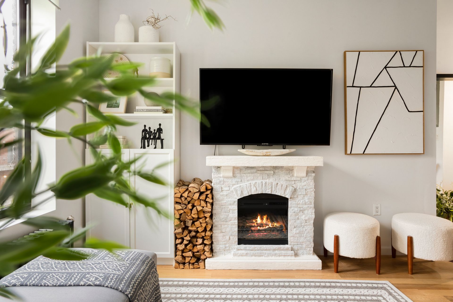A living room with a fireplace and a flat screen tv.