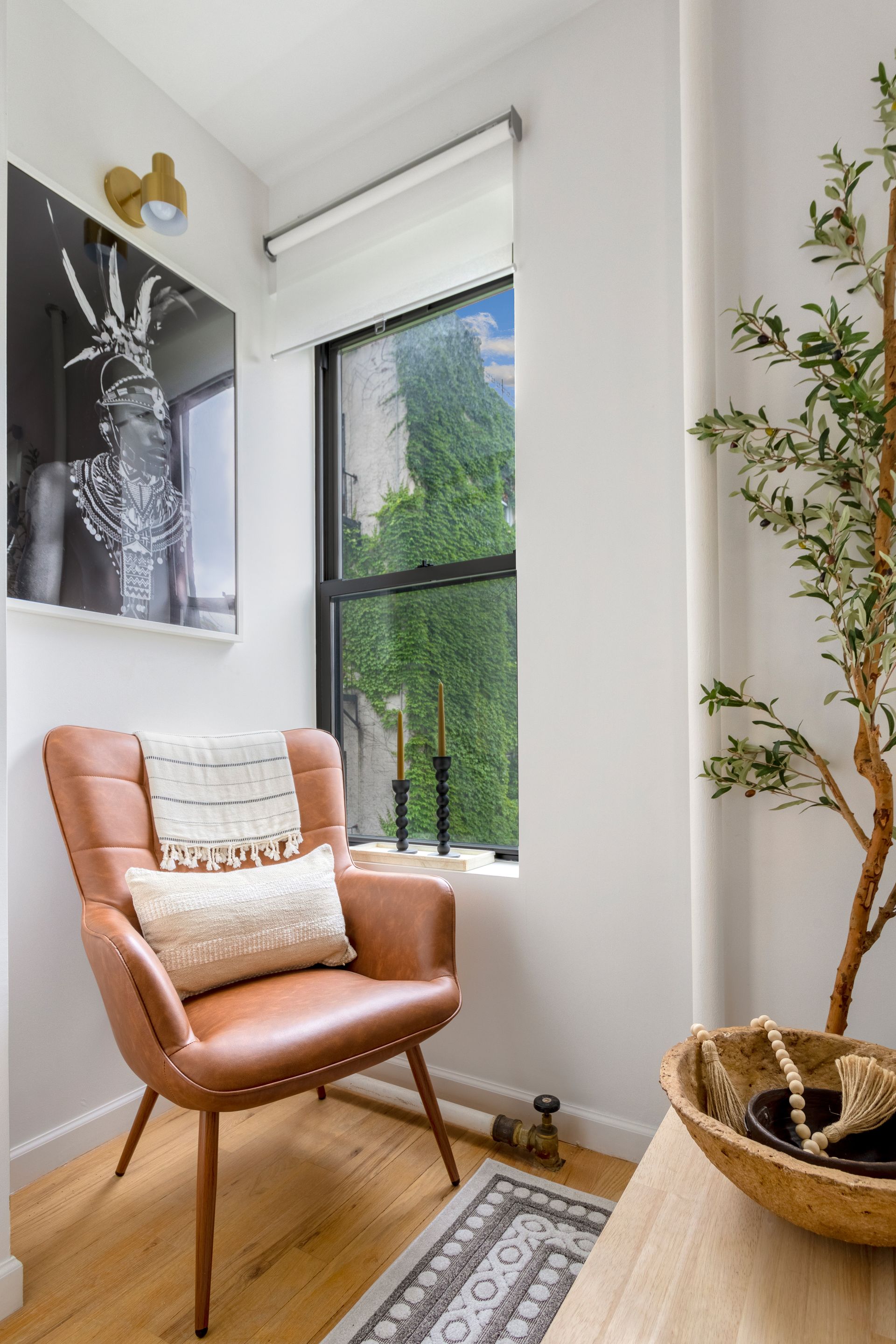 A chair is sitting in a corner of a room next to a window.