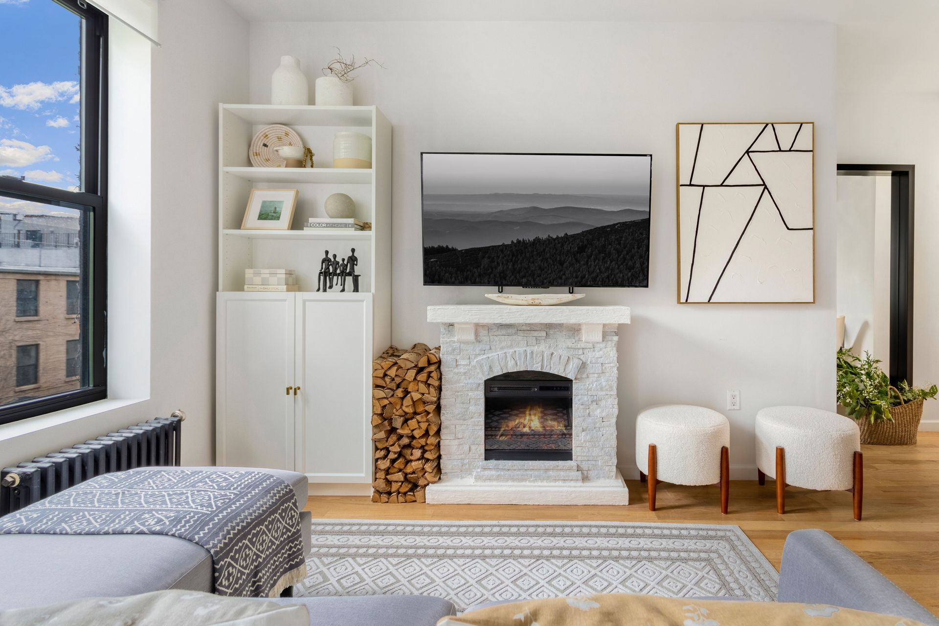 A living room with a fireplace and a flat screen tv