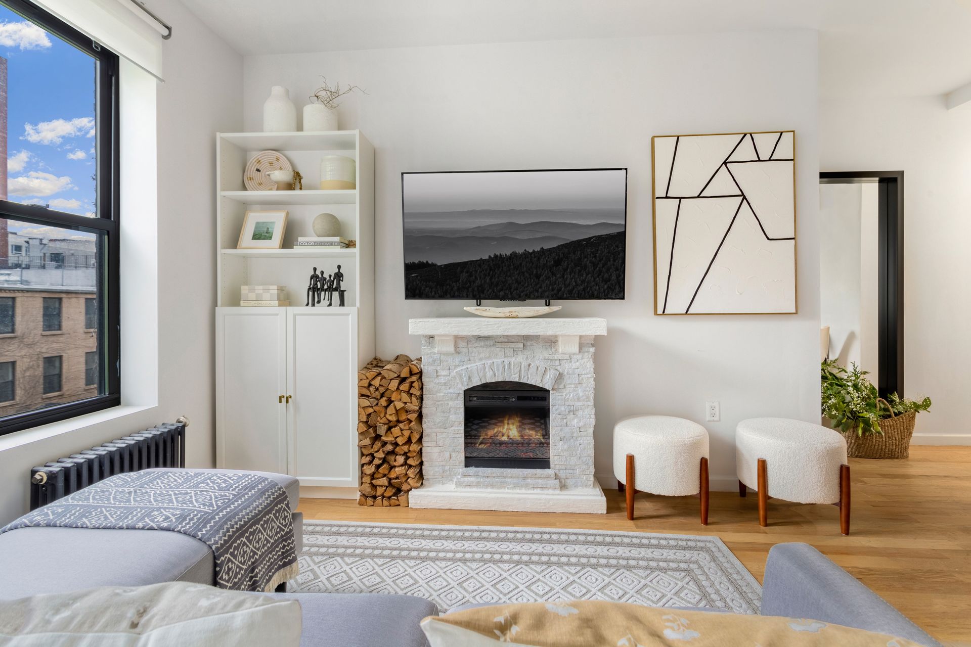 A living room with a fireplace and a flat screen tv.