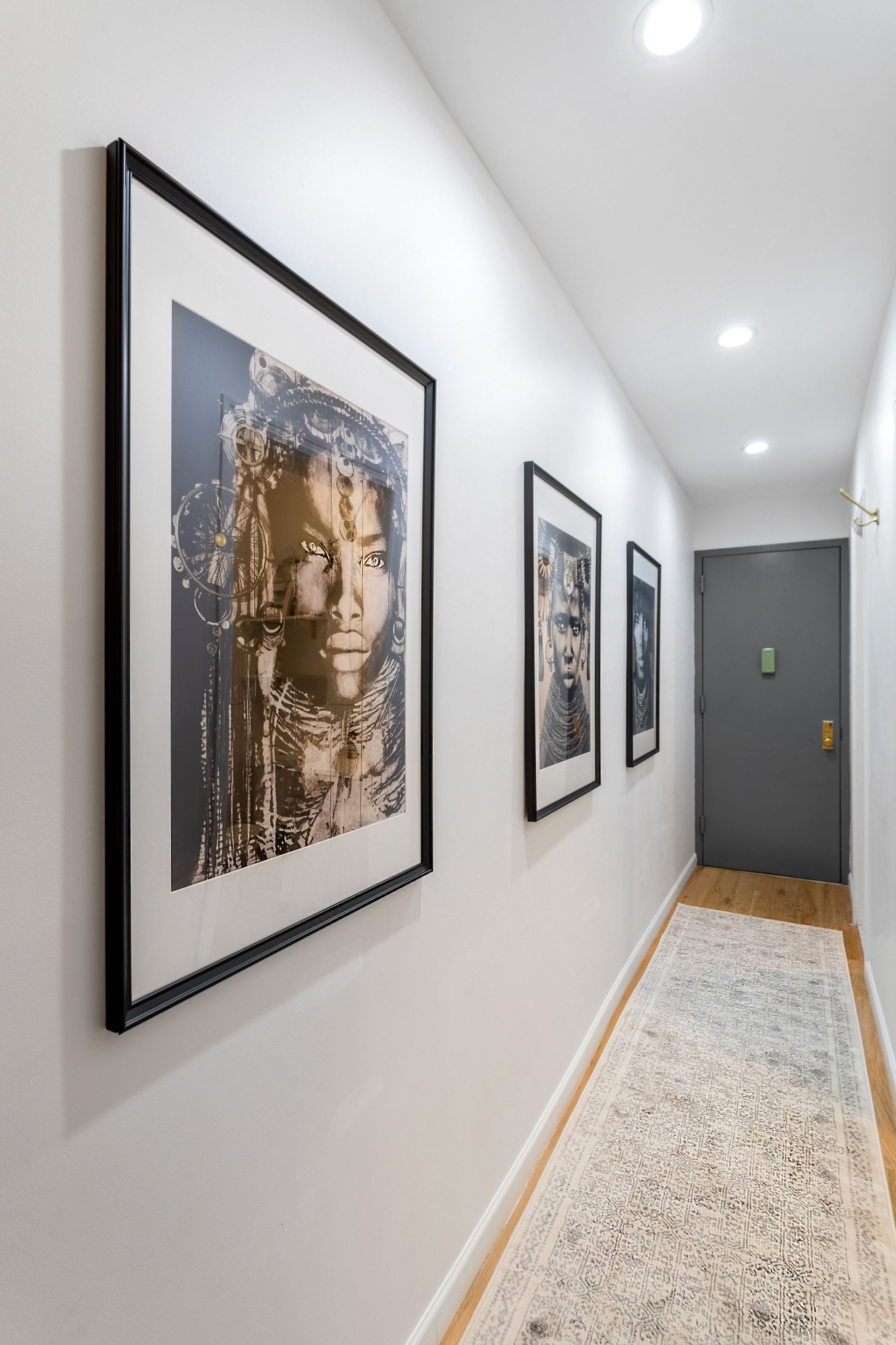 A hallway with a picture of a woman on the wall.