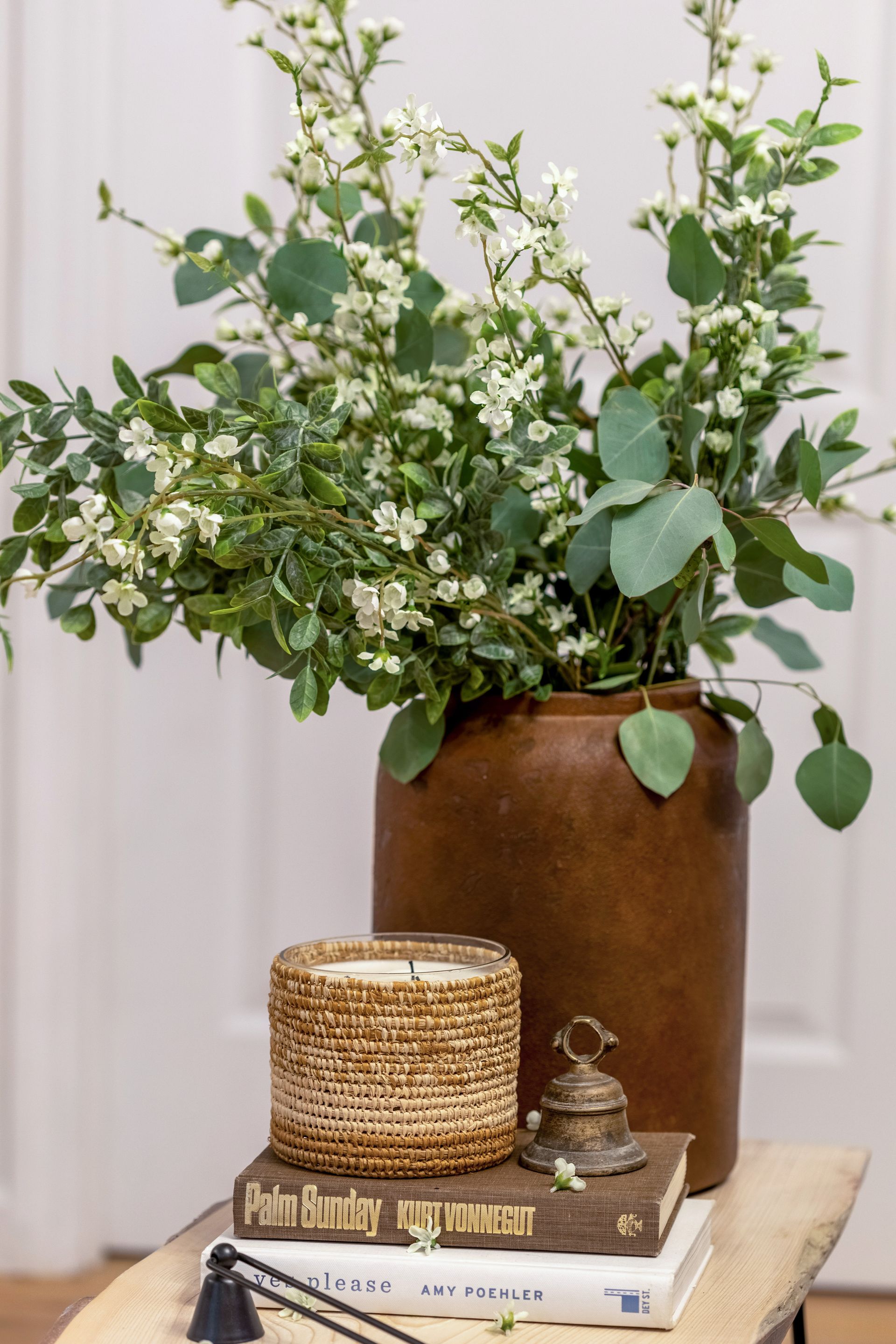 A vase filled with flowers is sitting on top of a wooden table.