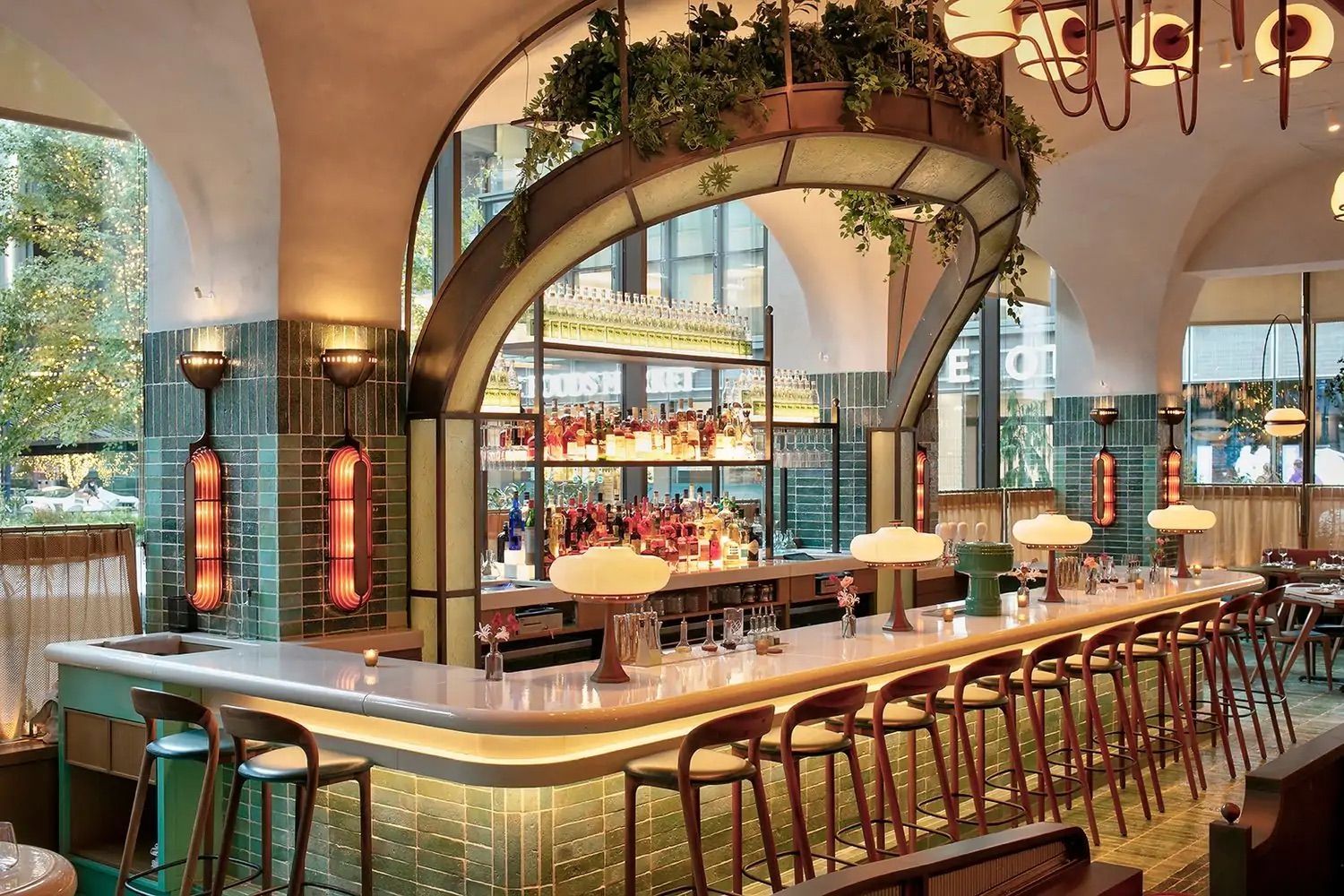 A long bar with a lot of stools in a restaurant.