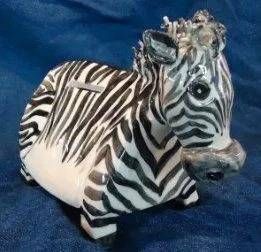 Kleine Zebrafigur mit schwarz-weissen Streifen auf blauem Hintergrund