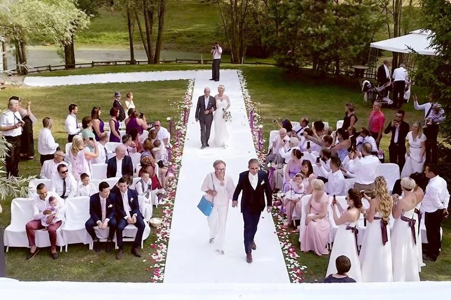 Les invités d'un mariage saluent la caméra.