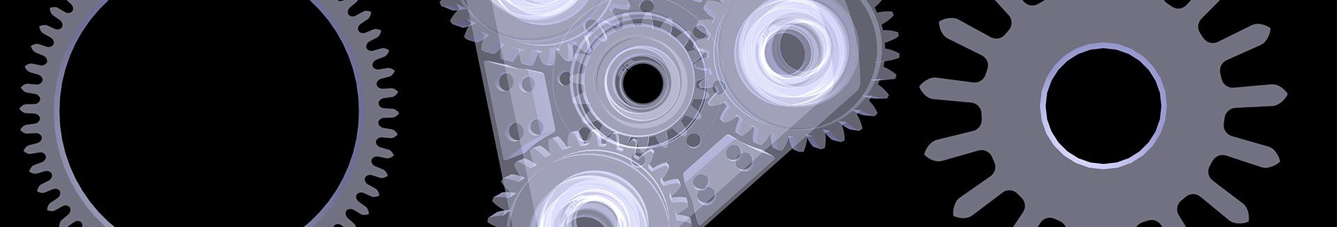 Eine Nahaufnahme von drei Zahnrädern auf schwarzem Hintergrund.