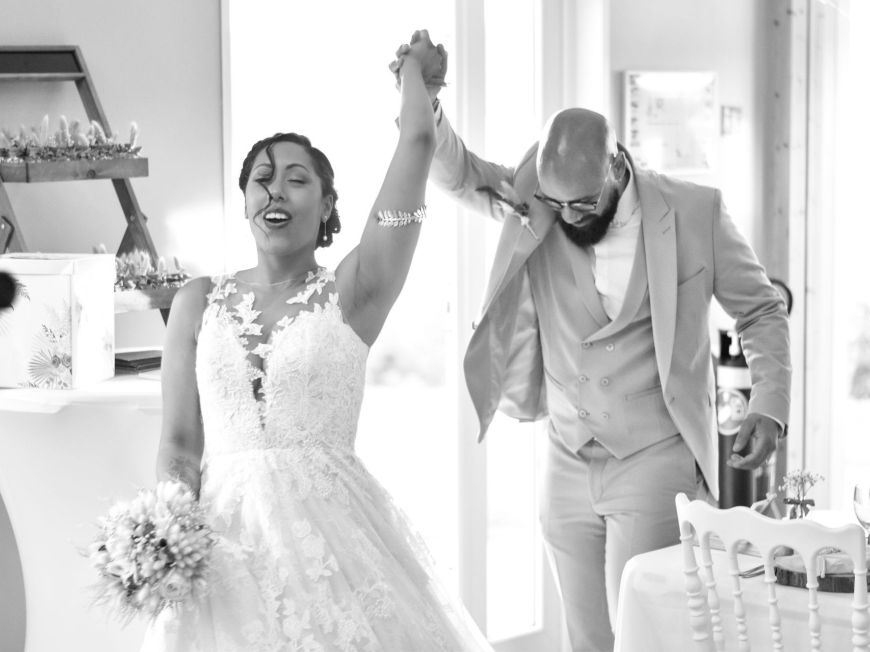 Deux mariés font leurs entrées en se tenant la main vers le ciel