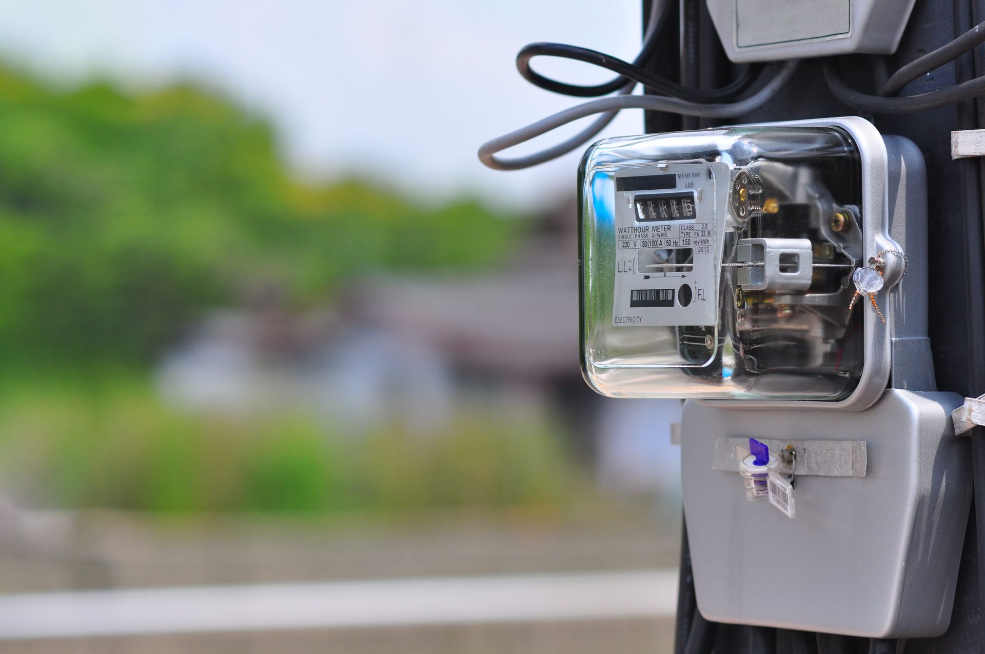Primer plano de un contador eléctrico montado en un poste de servicios públicos gris al aire libre