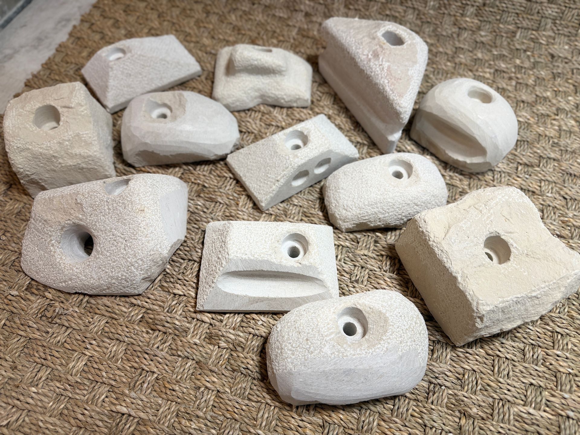 Prises d'escalade : formes assorties, couleur beige clair, avec trous pré-percés pour la fixation.