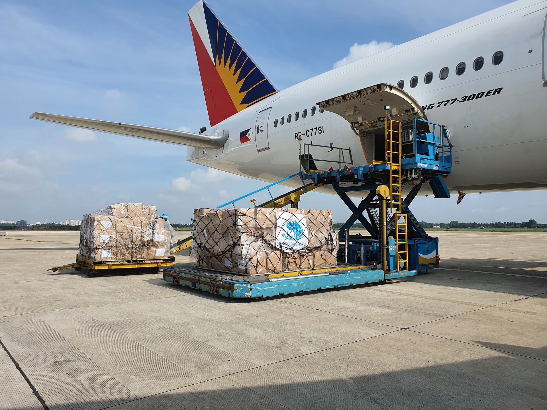 Chargement de marchandises à bord d’un avion de Philippine Airlines sur le tarmac