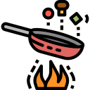 Una sartén se está cocinando en una estufa con llamas saliendo de ella.