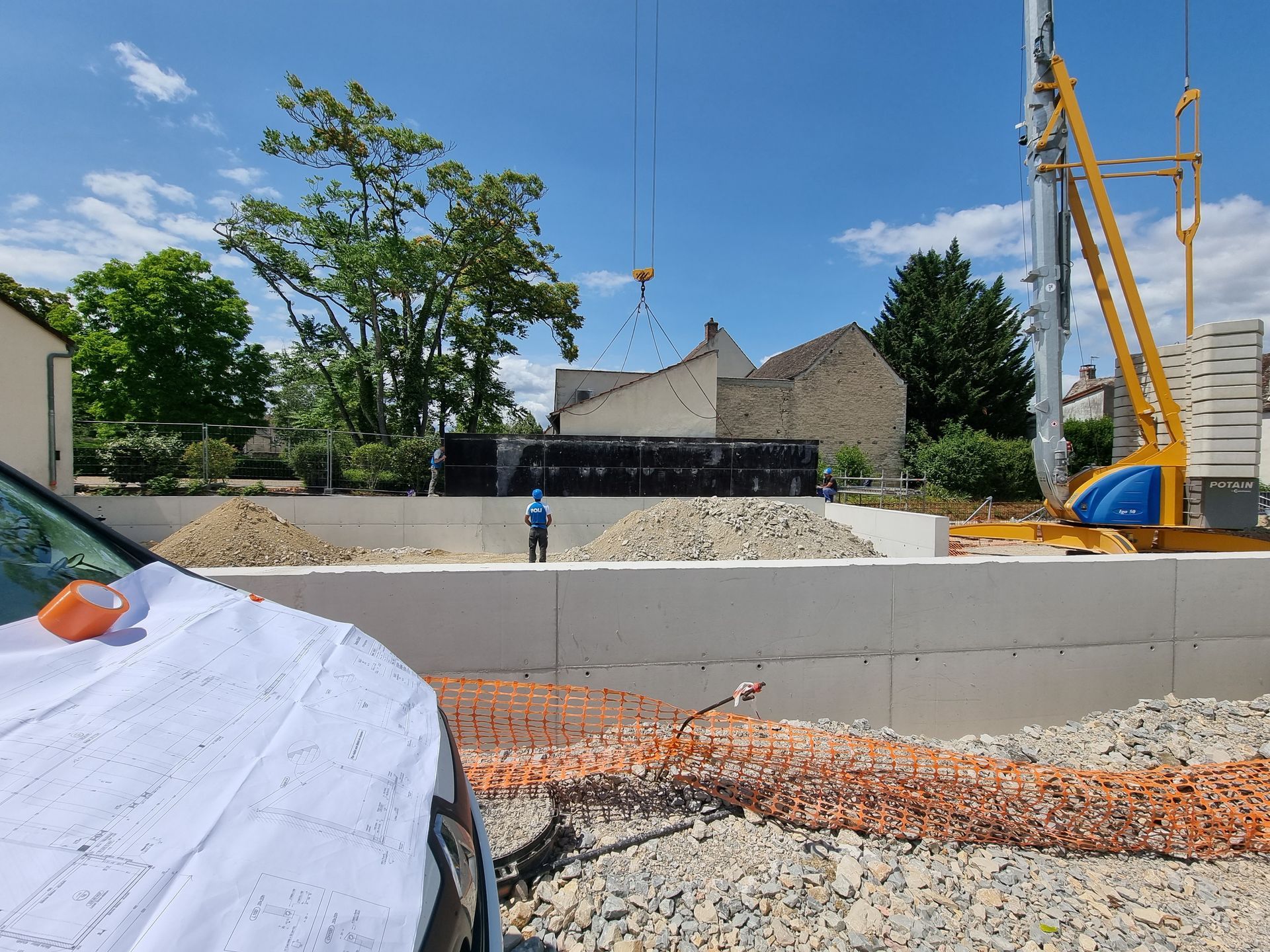 Chantier de construction avec une grue et des matériaux.
