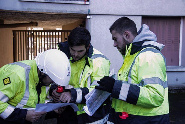 Trois personnes qui étudient un plan