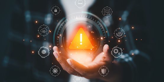 Eine Person hält ein Warnschild in den Händen.