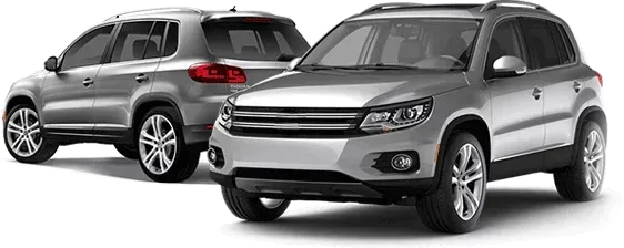Two silver cars are parked next to each other on a white background.