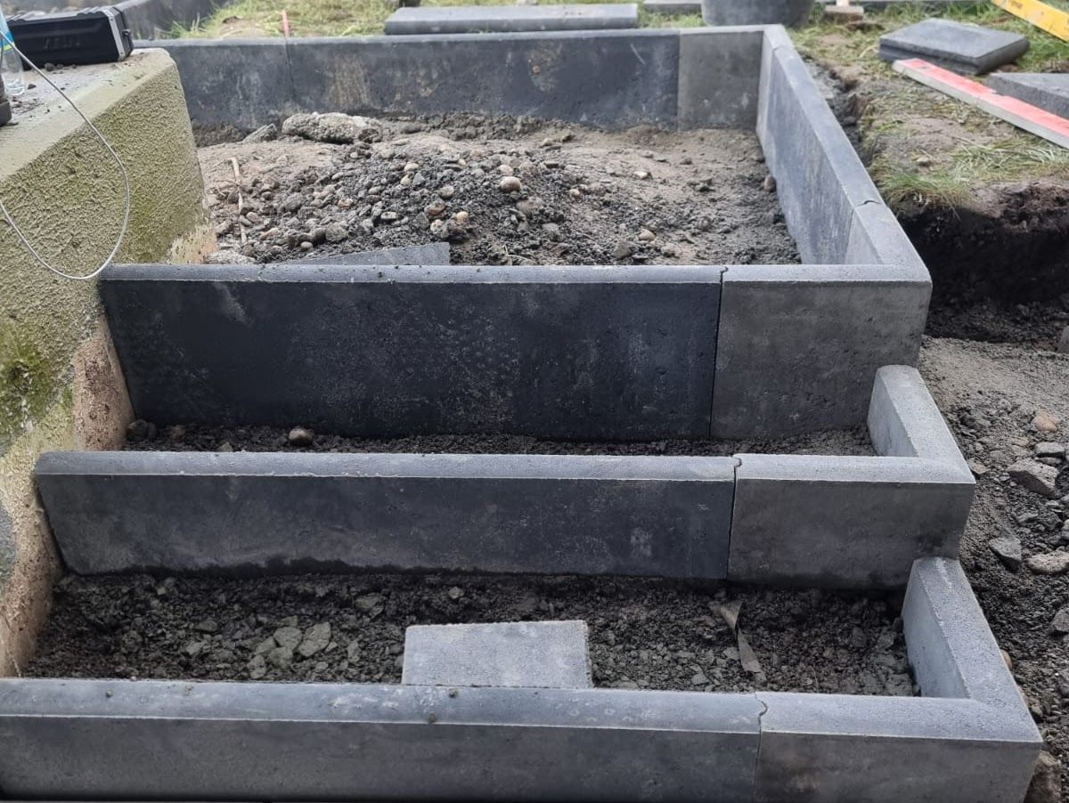 Steintreppen im Bau, graue Blöcke definieren die Struktur.