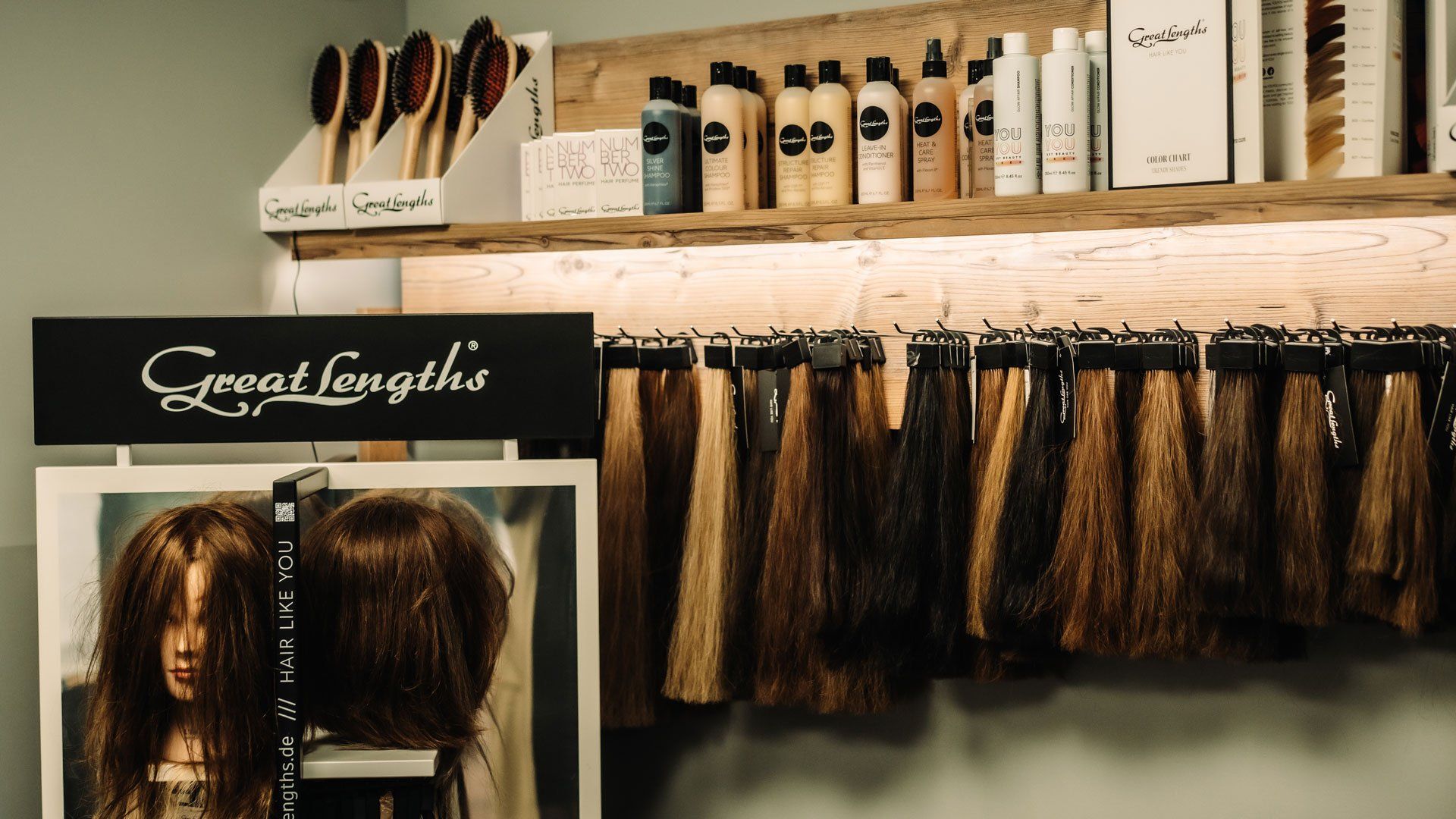 Hair extension samples and hair care products displayed in a salon.