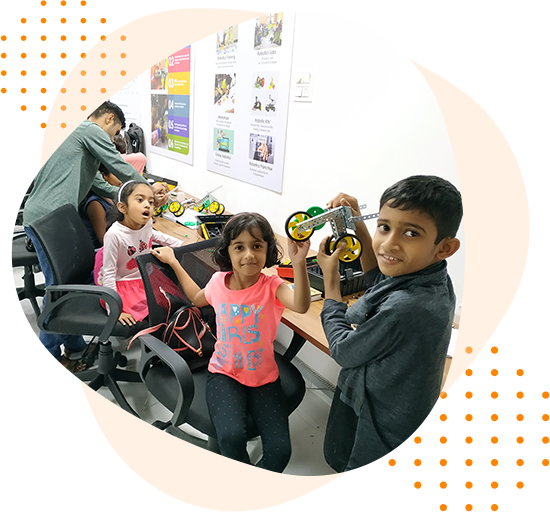 A group of children are sitting at a table playing with toys.