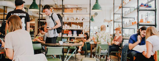 A remote control truck is sitting on the ground next to a remote control.