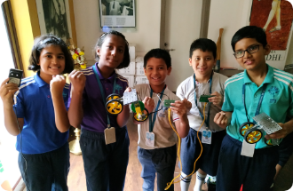 A group of children are posing for a picture with medals around their necks