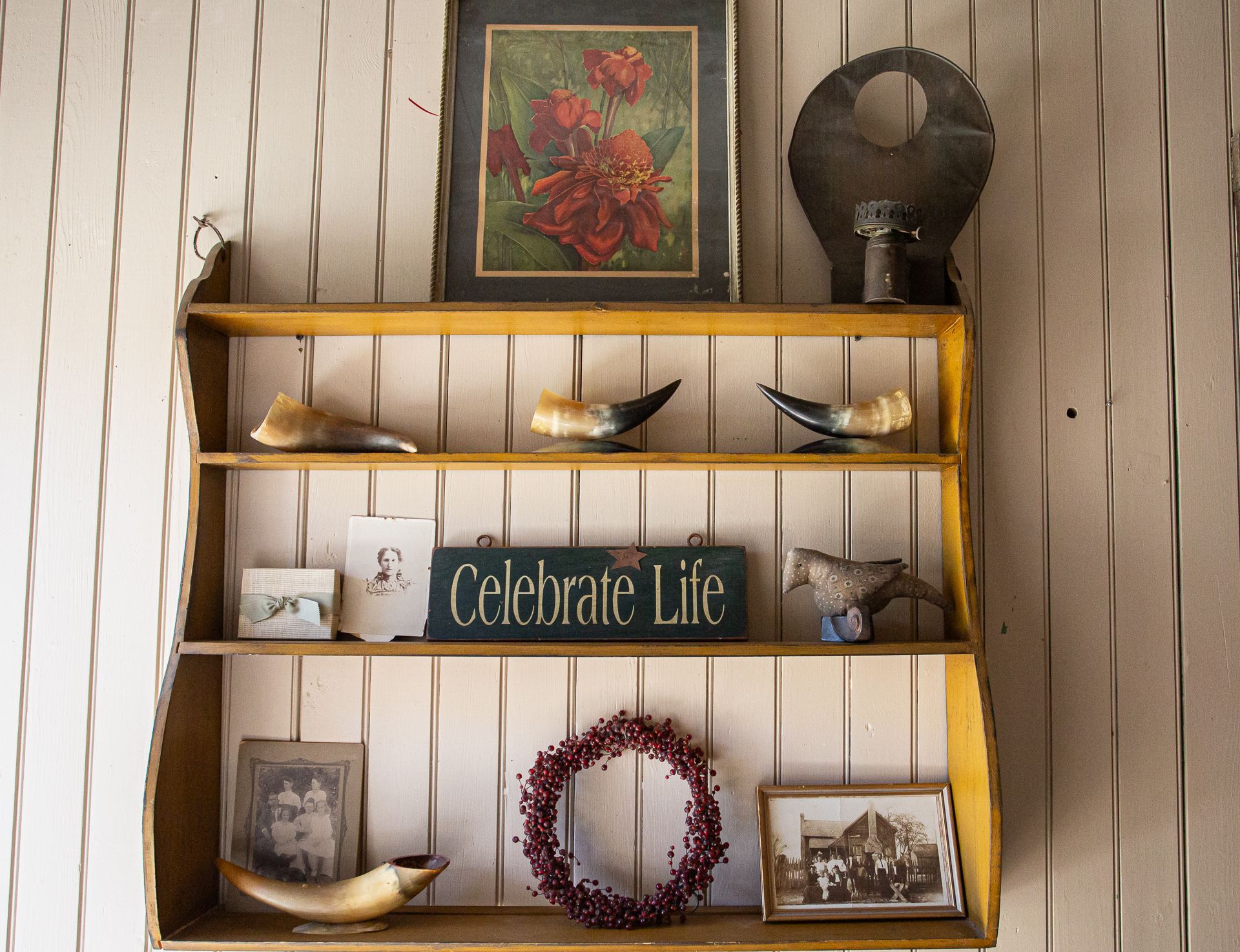 A shelf with a sign that says celebrate life on it