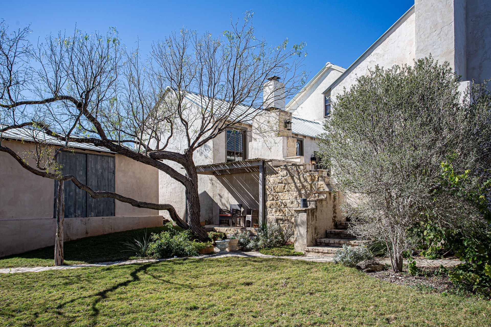 A large house with a tree in front of it.