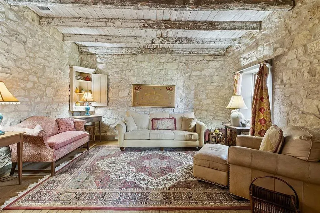A living room filled with furniture and a rug.