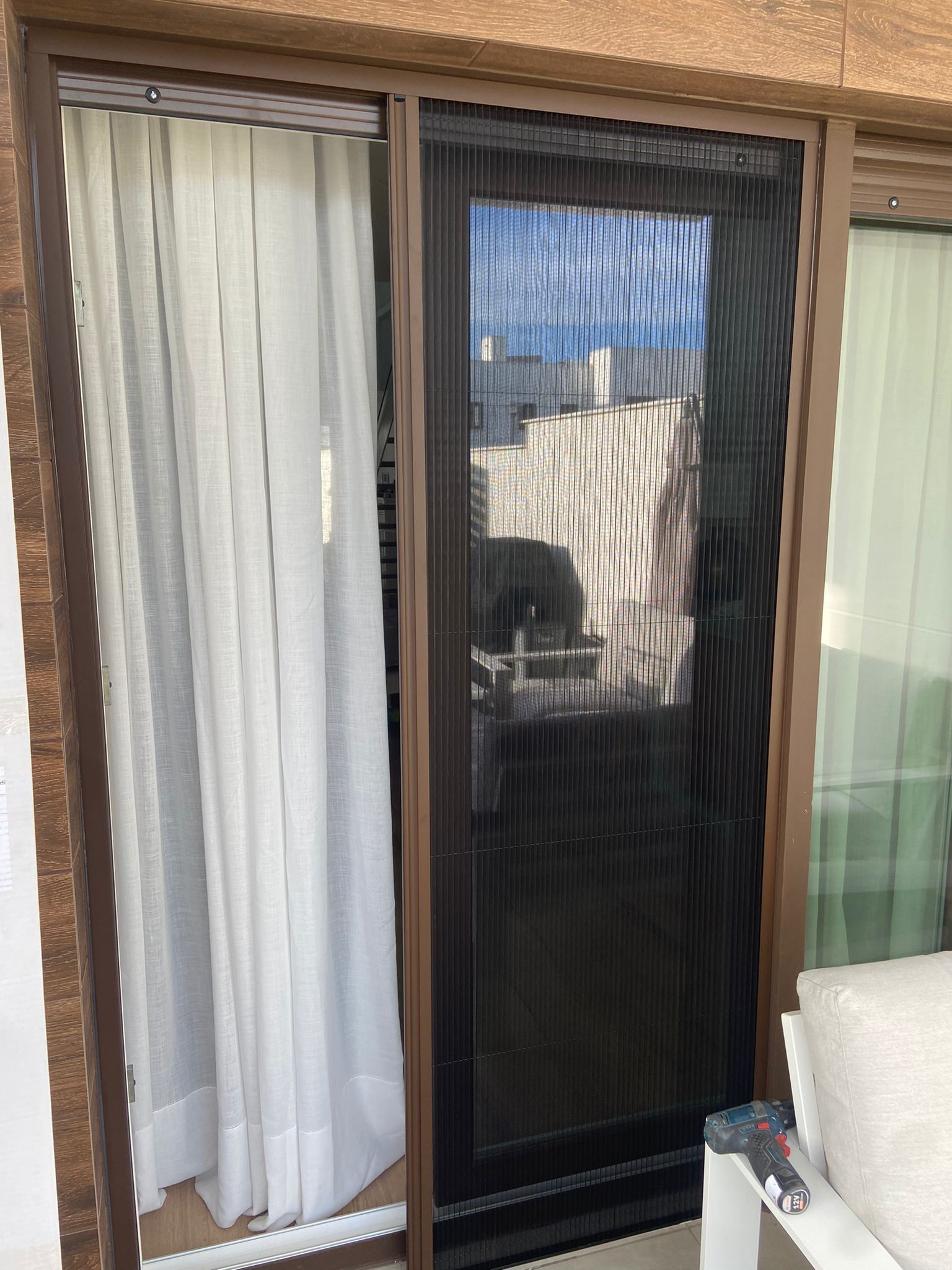 Una puerta corrediza de vidrio con mosquitera.
