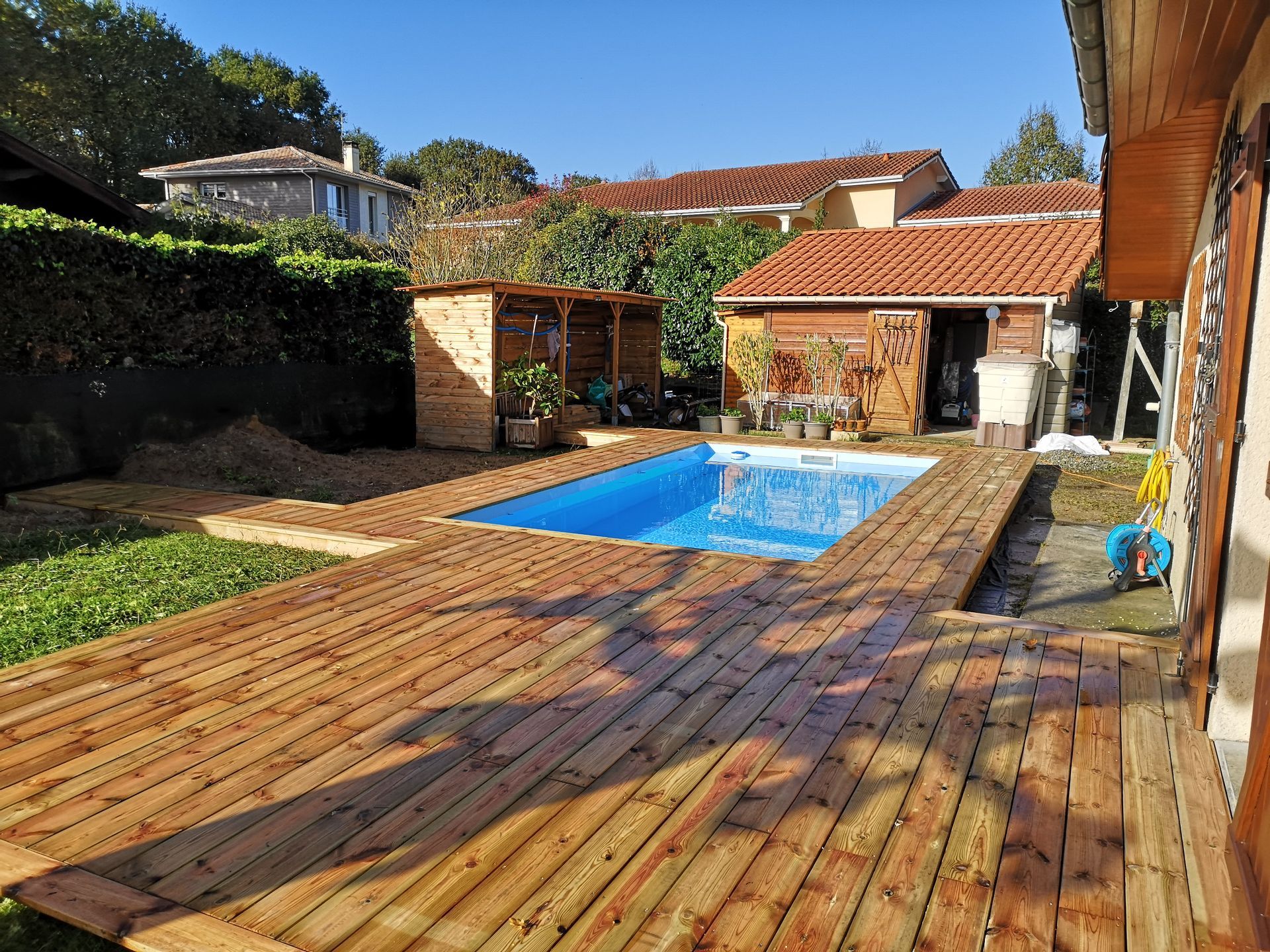 Piscine rectangulaire avec terrasse et margelle en bois