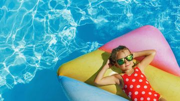 Une fillette sur un matelas gonflable dans l'eau
