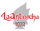 Logotipo de LaAntorcha en rojo y gris con el texto “1973” y “des de l'any”.