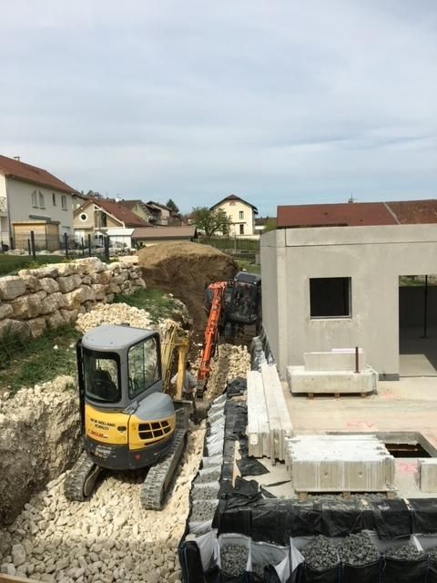 Engin réalisant des travaux de terrassement pour la maison d'un particulier