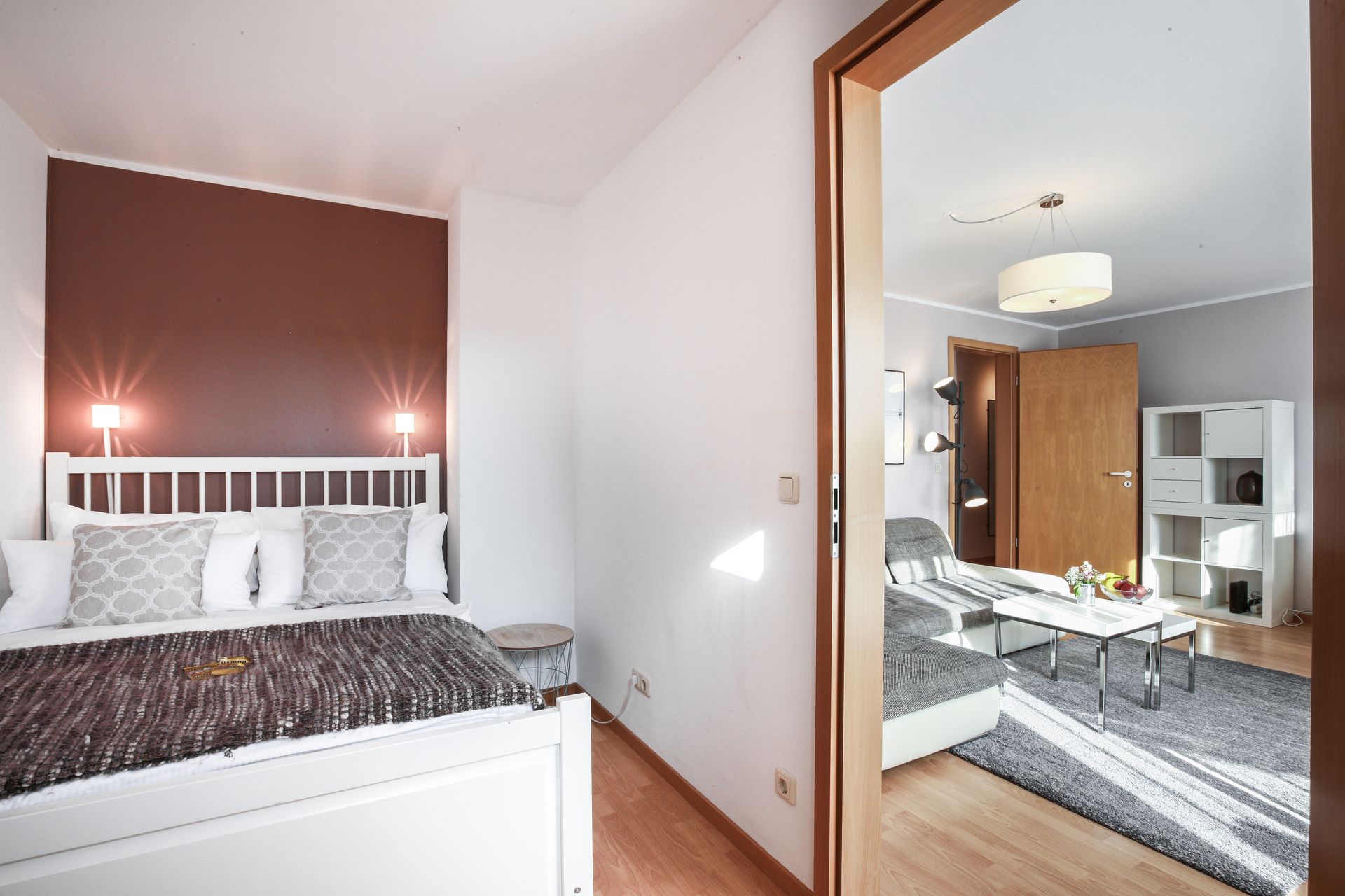 A bedroom with a king size bed and a living room