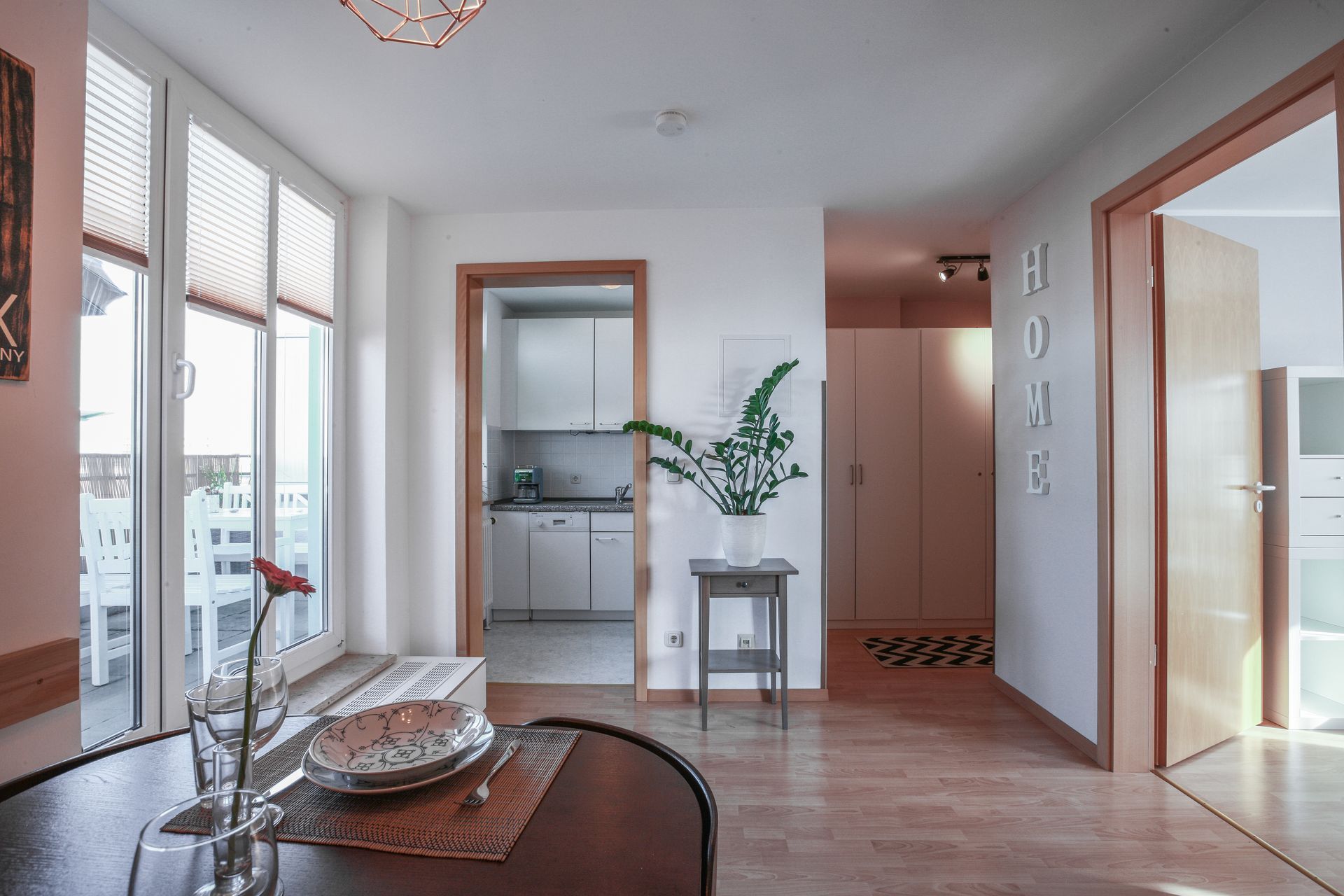 A living room with a table and a vase of flowers