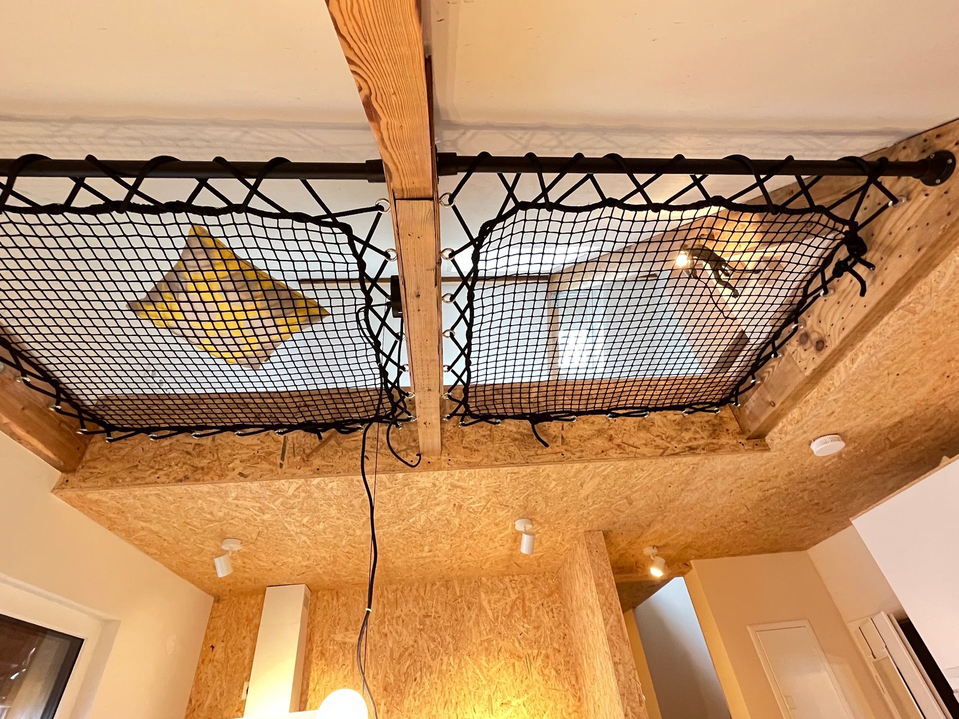 A room with a ceiling that has a net on it