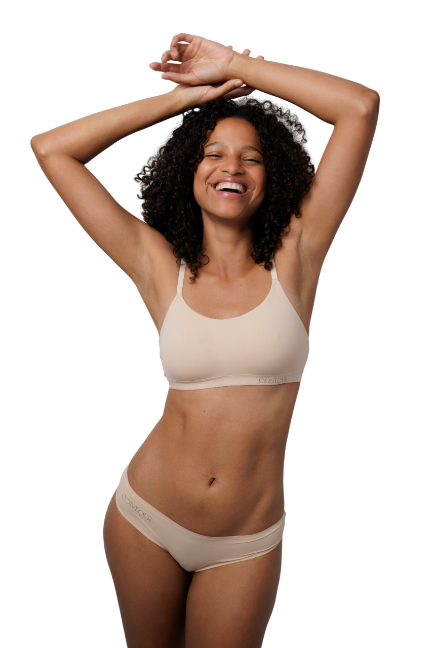 Femme souriante, les bras levés.