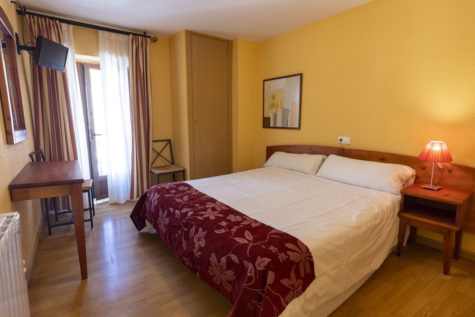 Una habitación de hotel con una cama tamaño king y una mesa.