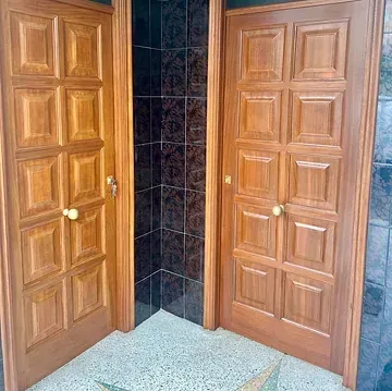 Hay dos puertas de madera una al lado de la otra en una habitación.
