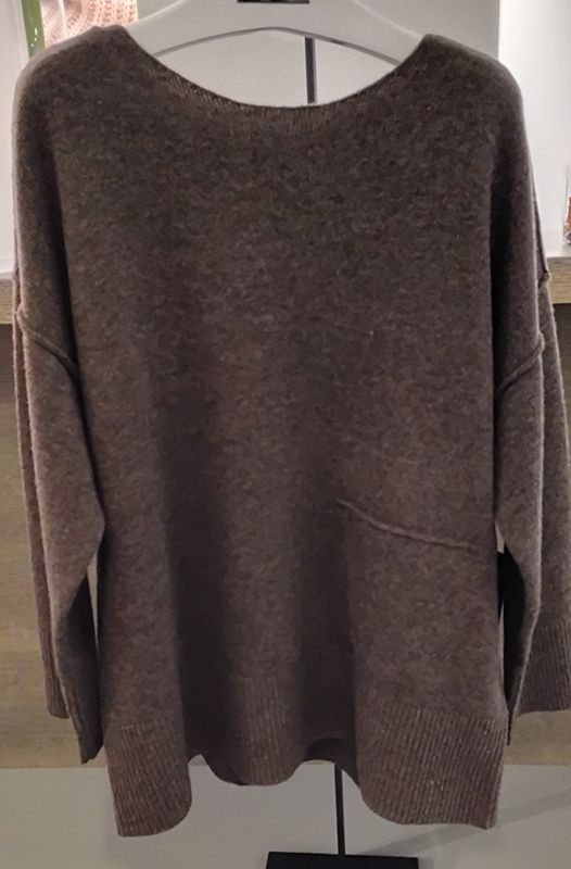 Brauner Pullover auf einem Kleiderbügel mit U-Boot-Ausschnitt und schrägen Nahtdetails.