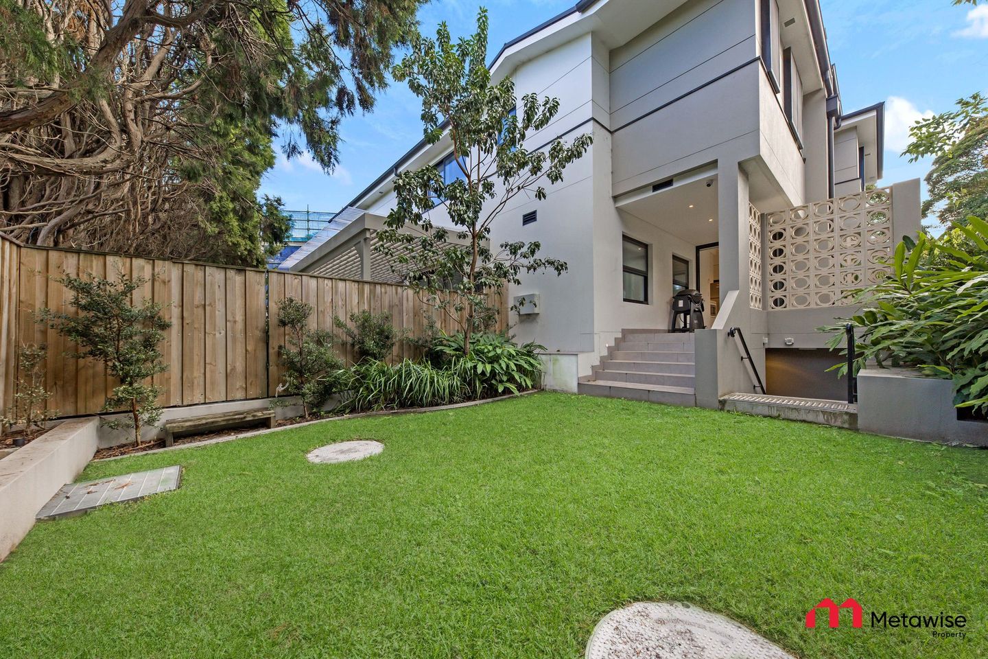 A house with a large lawn in front of it