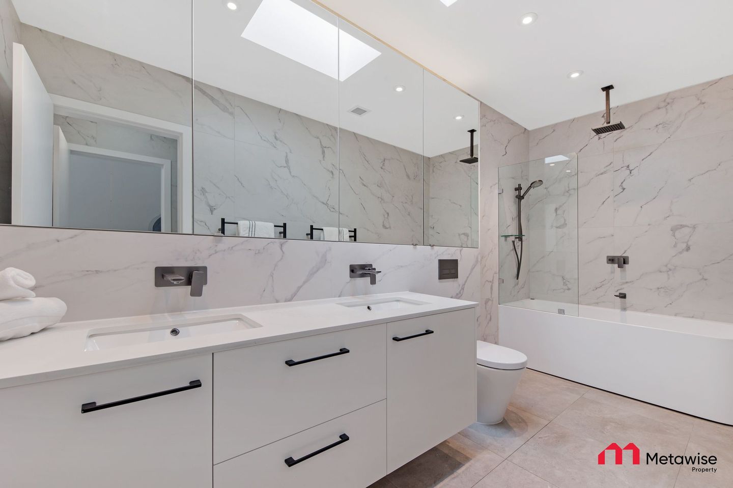 A bathroom with a sink , toilet , shower and bathtub.