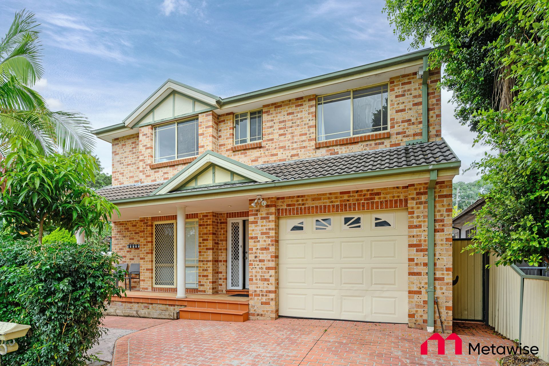 A large brick house with a white garage door