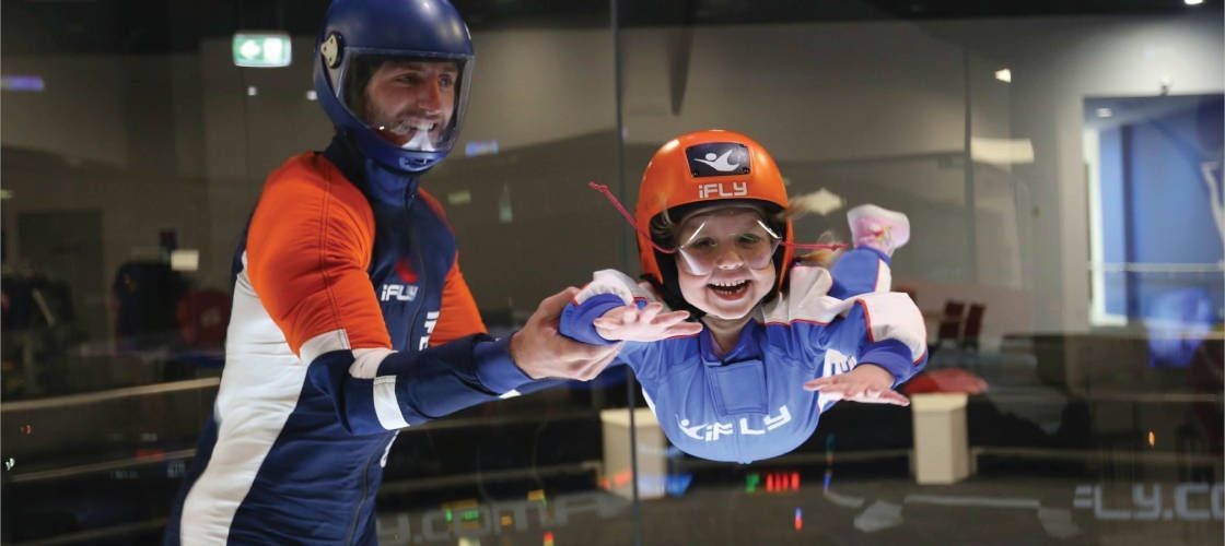 A man and a child are flying through a glass wall.