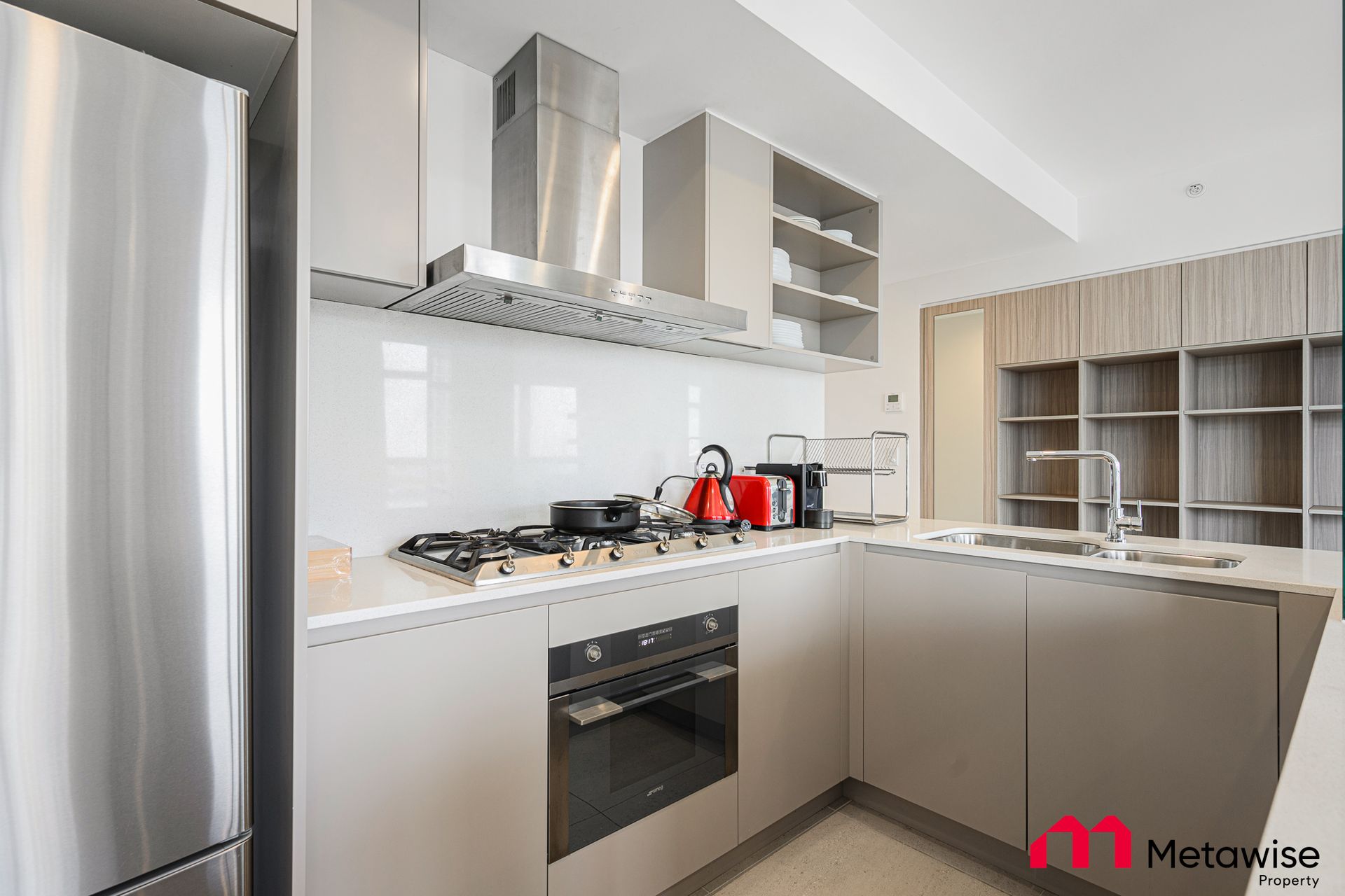 A kitchen with stainless steel appliances and white cabinets.