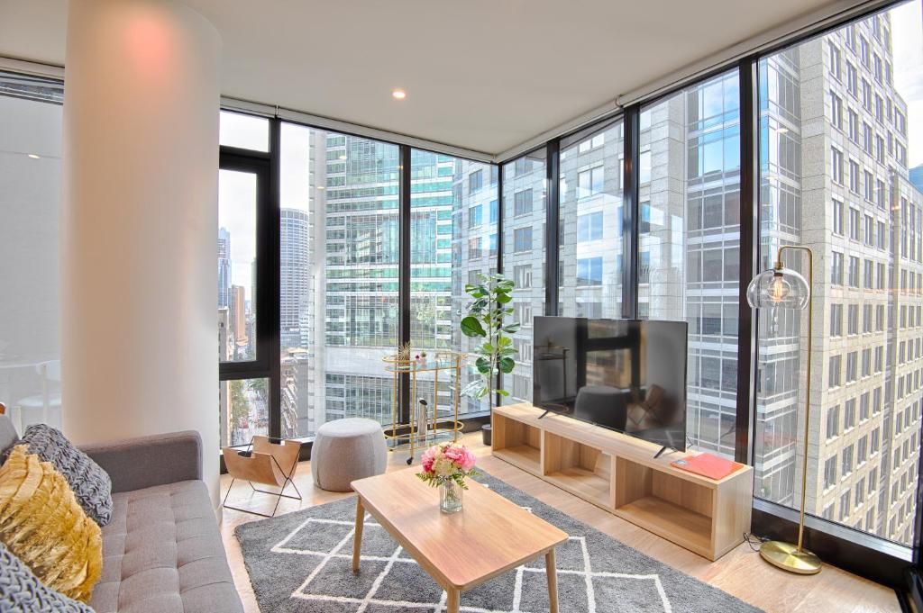 A living room with a couch , coffee table , and television.