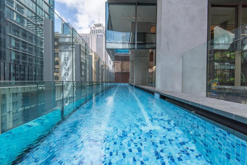 There is a large swimming pool in the middle of a building.