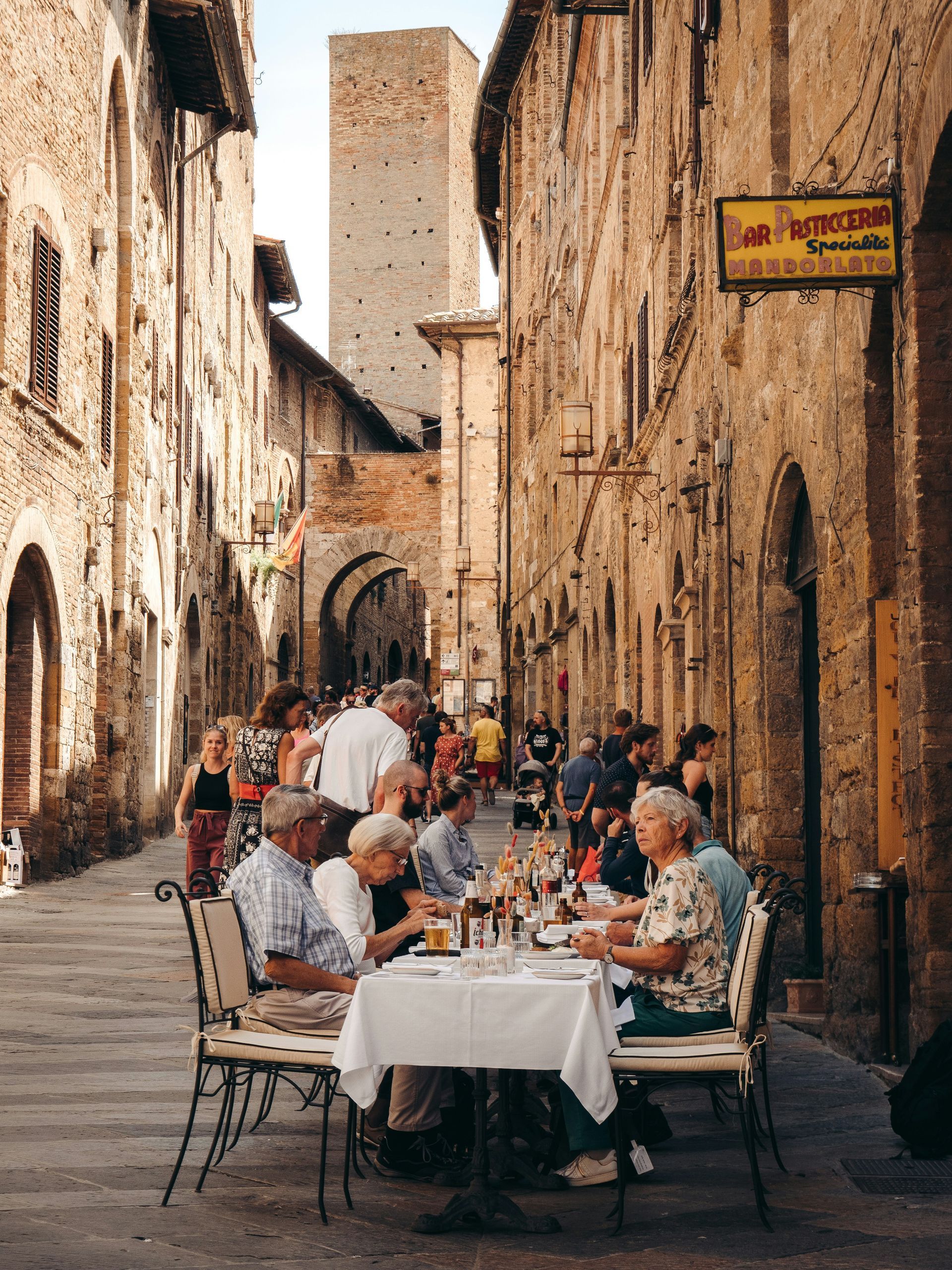 Group of friends dining together at a European outdoor restaurant