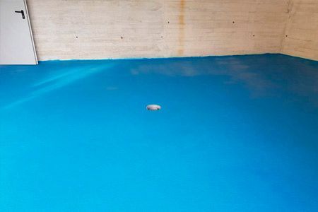 Un piso azul en una habitación con una puerta blanca.