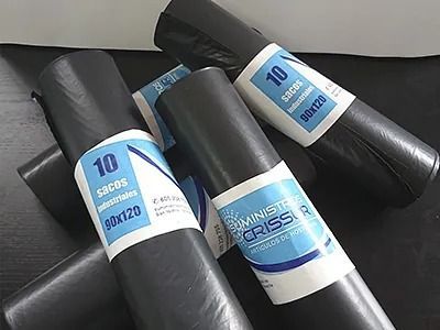 Tres bolsas de basura están apiladas una encima de otra sobre una mesa.