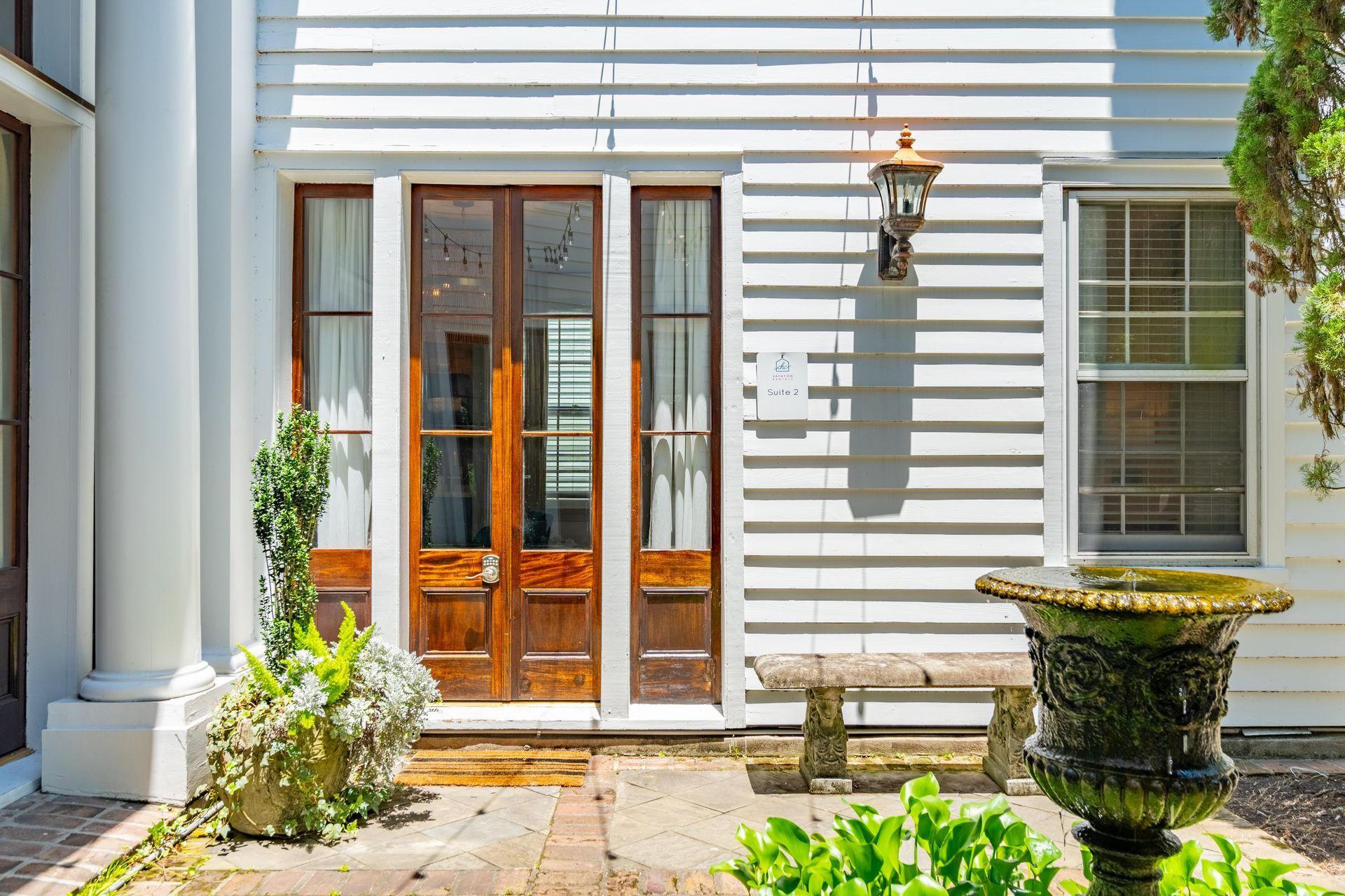 a wooden entrance door to a beautiful looking house